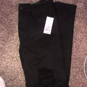Women’s black ripped skinny jeans
